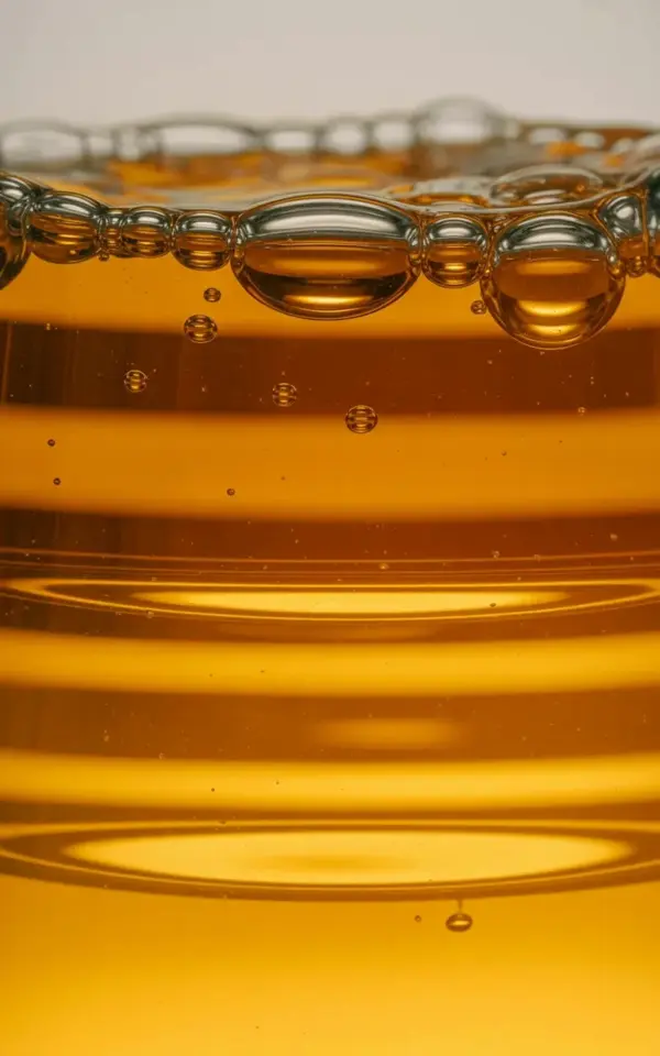 Fall Cocktail Macro Shot with Amber Liquid & Golden Bubbles